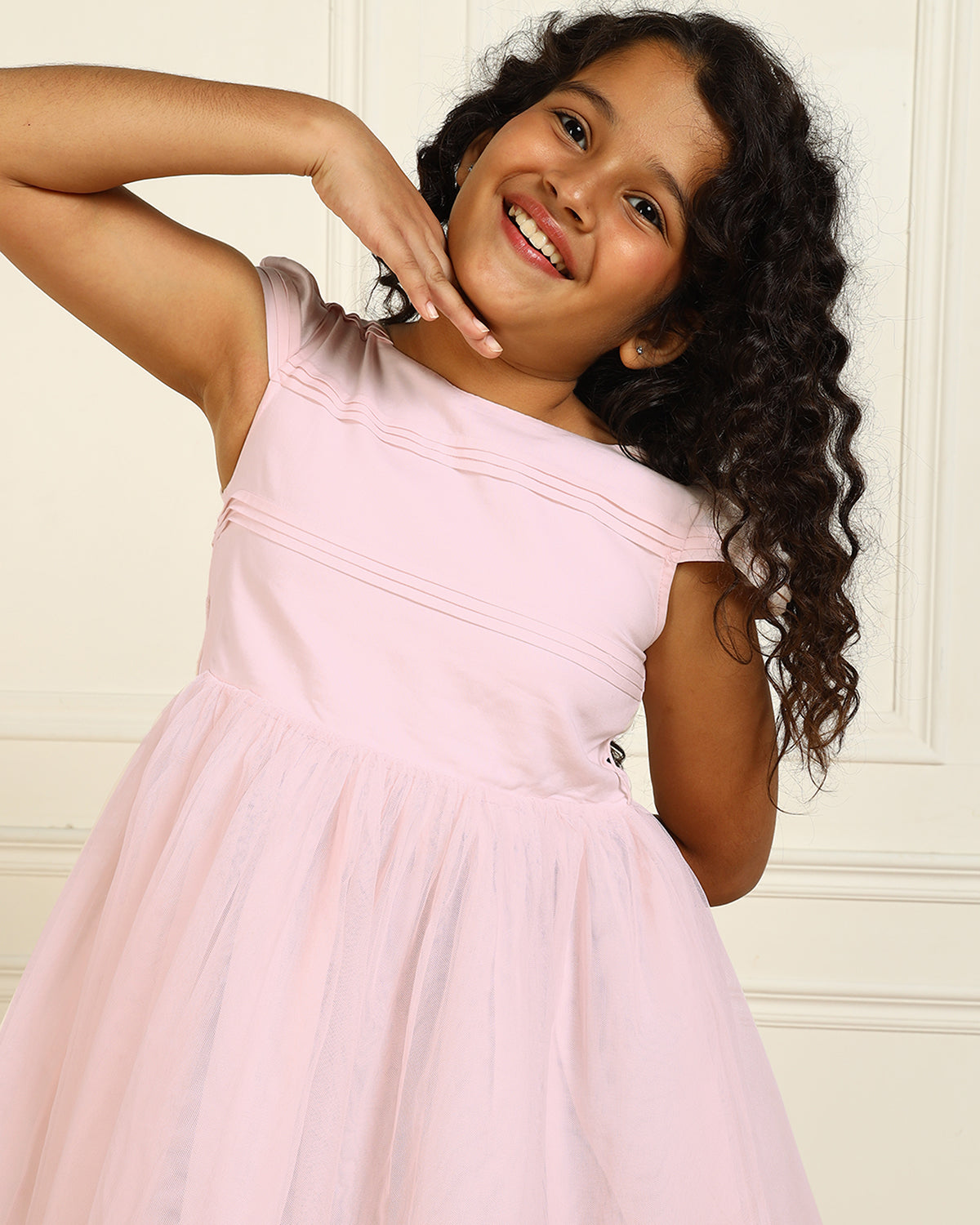 Pink girls sleeveless fit and flare dress with pleated skirt and flared hem