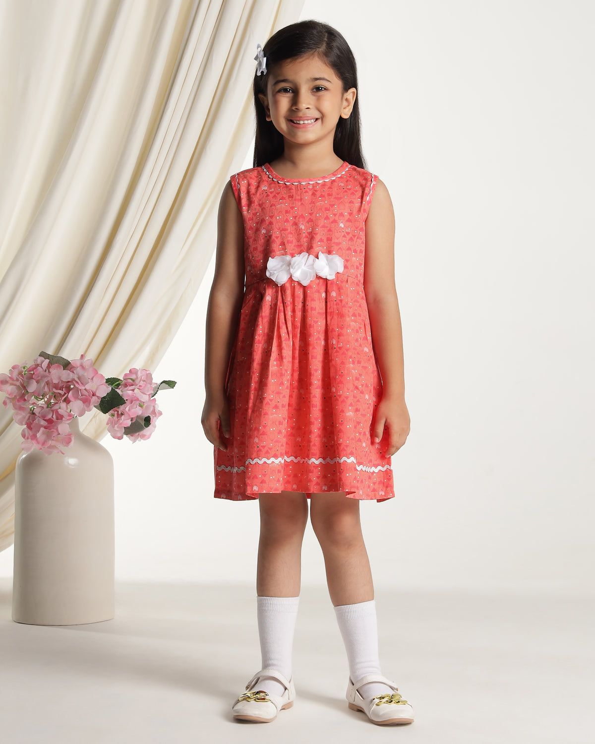 Coral girls sleeveless fit and flare dress with floral embroidery and flared hem