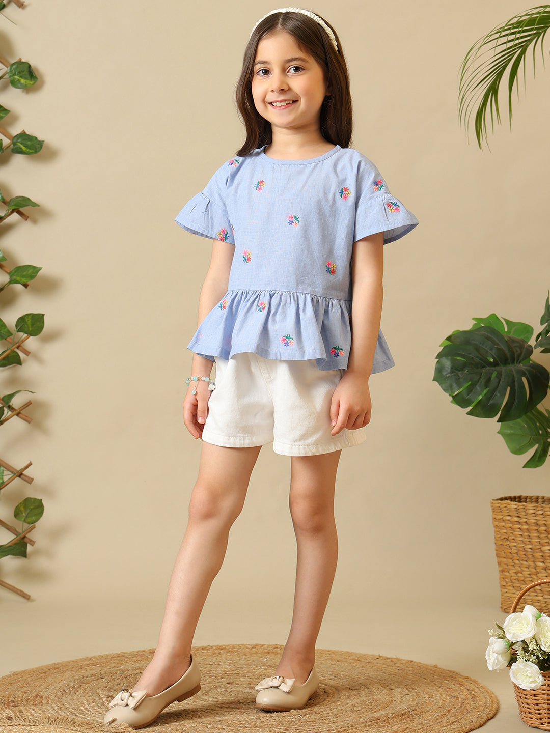 Blue girls printed short sleeve top with ruffle detailing and white shorts