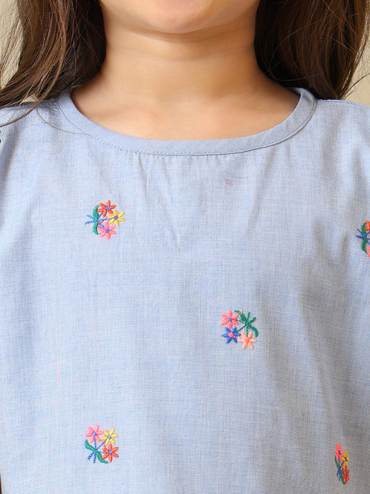 Blue girls printed short sleeve top with ruffle detailing and white shorts