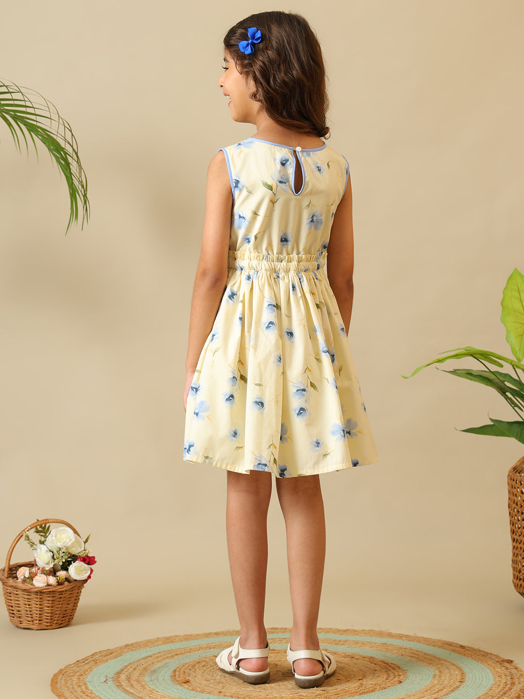 Cream girls floral printed fit and flare dress with sleeveless design and gathered waist
