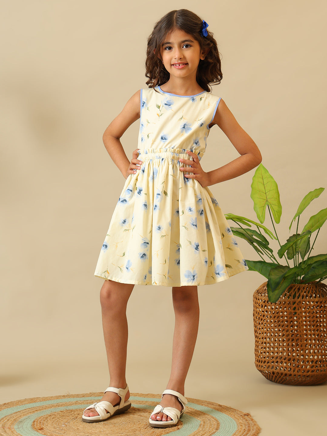 Cream girls floral printed fit and flare dress with sleeveless design and gathered waist