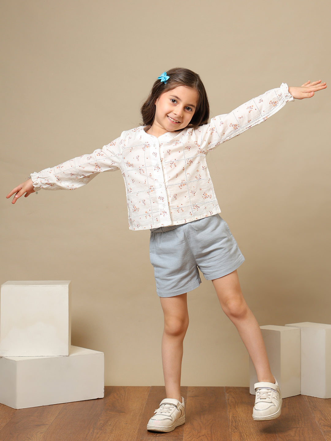 White girls floral embroidered long sleeve top with ruffle detailing and blue shorts