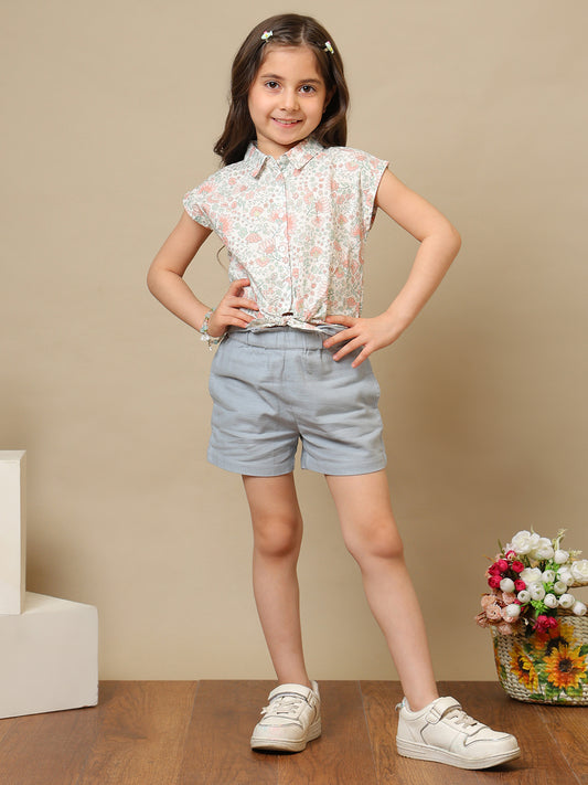 White girls floral printed sleeveless top with ruffle detailing and blue shorts