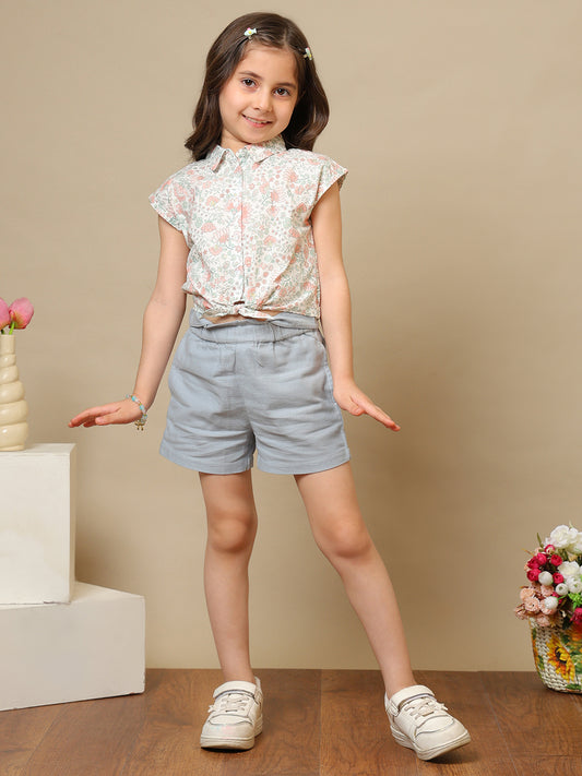 White girls floral printed sleeveless top with ruffle detailing and blue shorts