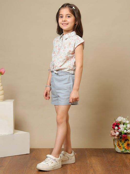 White girls floral printed sleeveless top with ruffle detailing and blue shorts