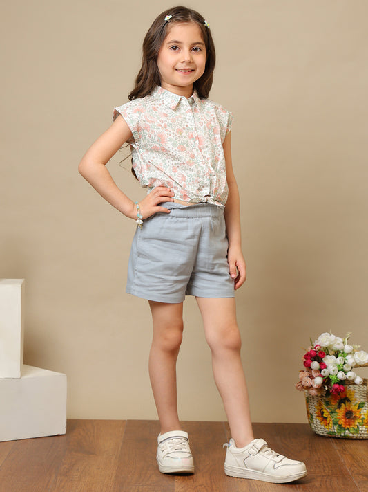 White girls floral printed sleeveless top with ruffle detailing and blue shorts