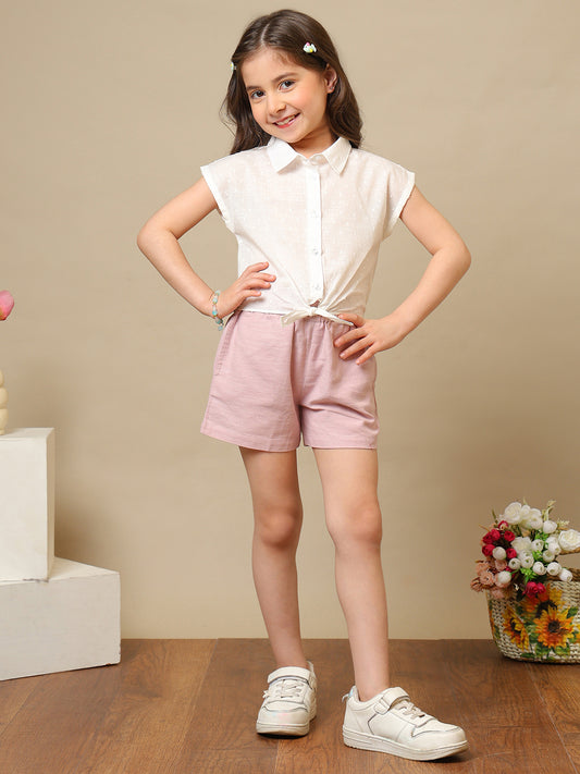 White girls sleeveless top with ruffle detailing and pink shorts co-ord set