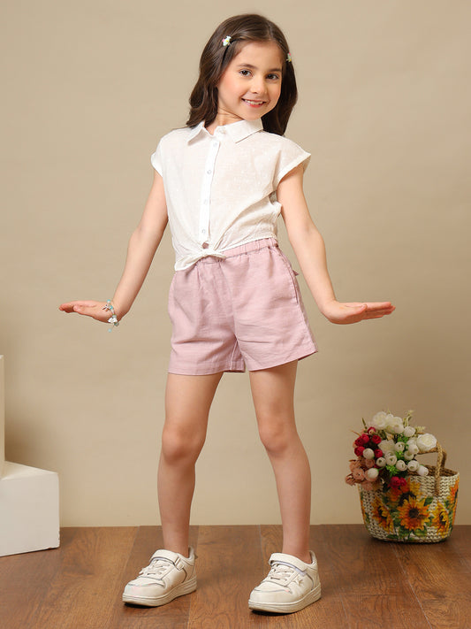 White girls sleeveless top with ruffle detailing and pink shorts co-ord set