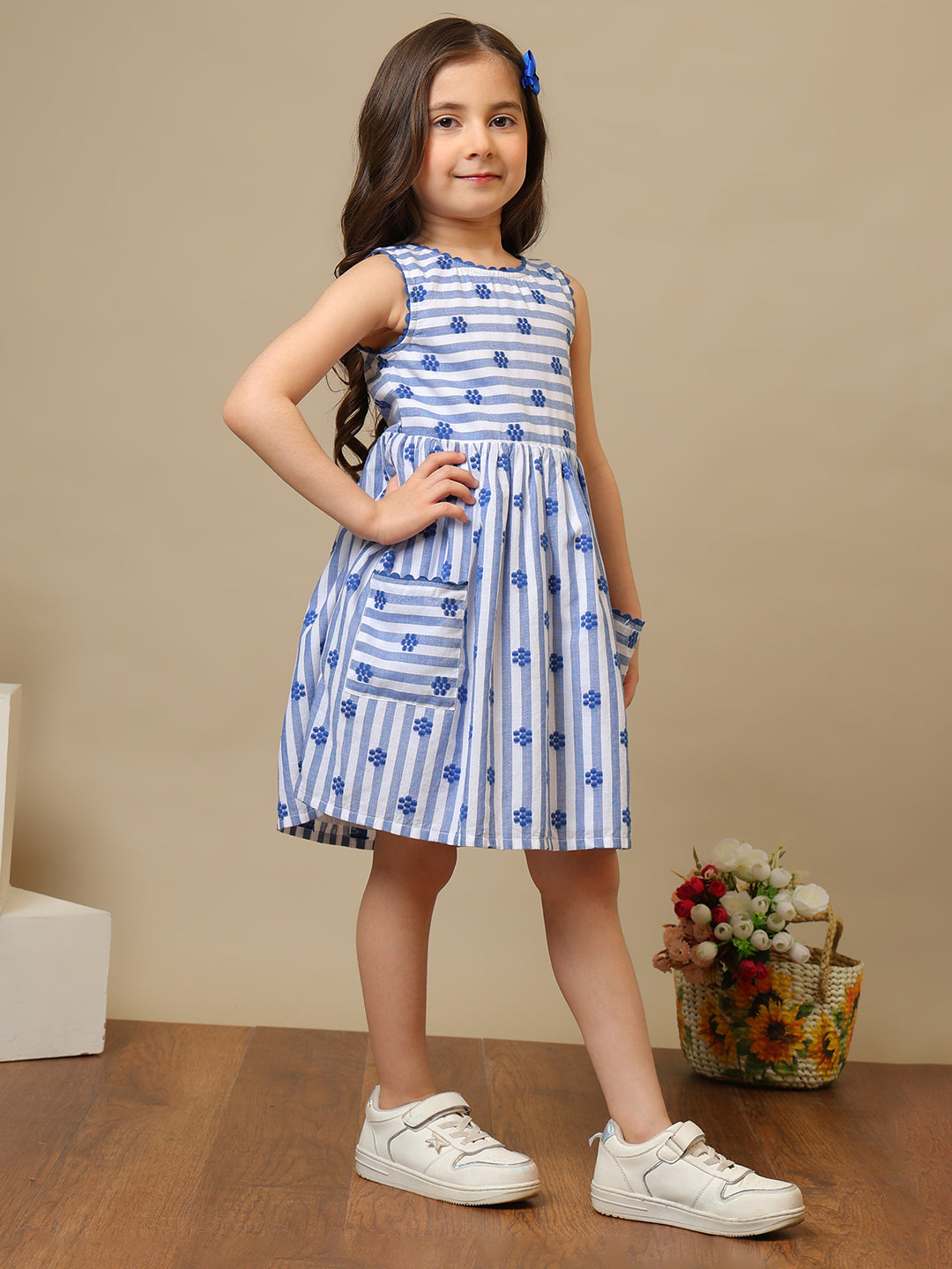 Blue and white striped girls sleeveless dress with floral print and ruffle hem