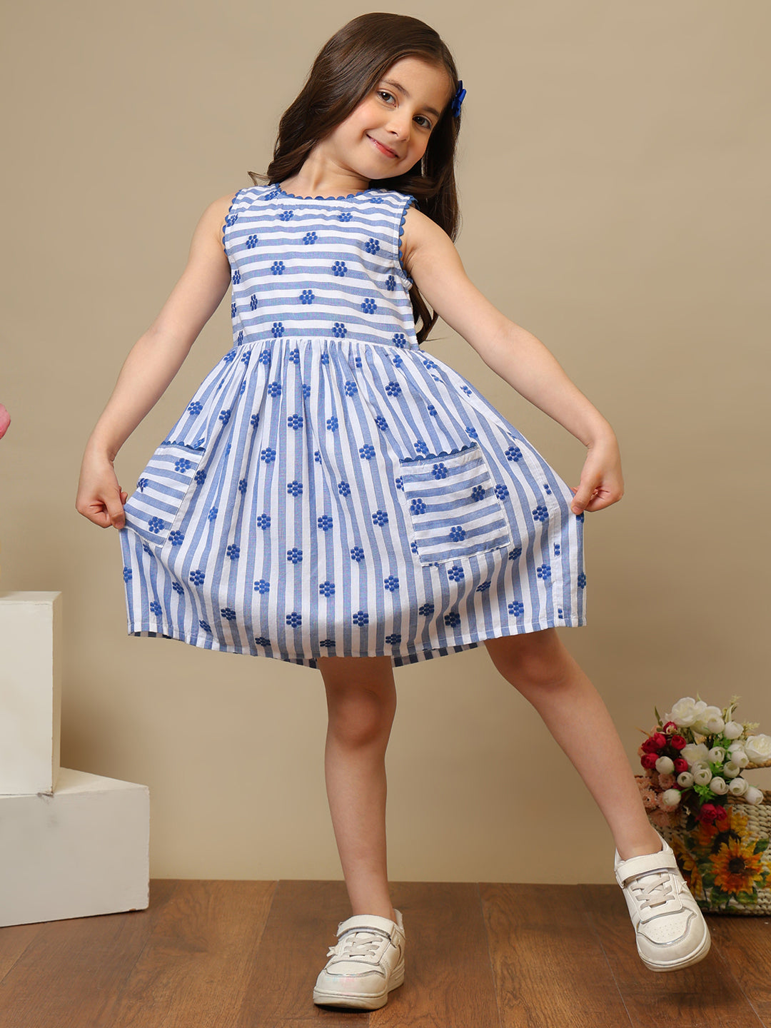 Blue and white striped girls sleeveless dress with floral print and ruffle hem