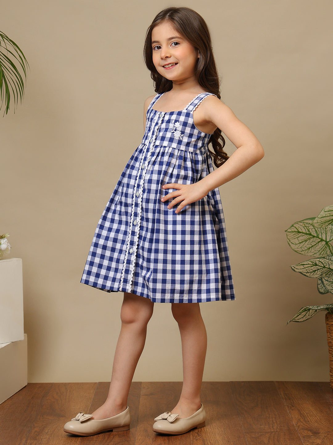 Blue and white gingham girls sleeveless A-line dress with shoulder straps and flared hem