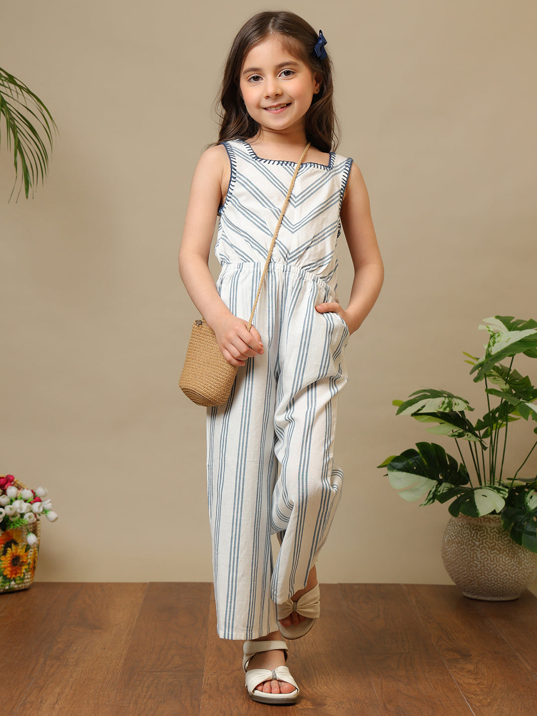 Blue and white striped girls sleeveless jumpsuit with wide-leg pants and chevron pattern