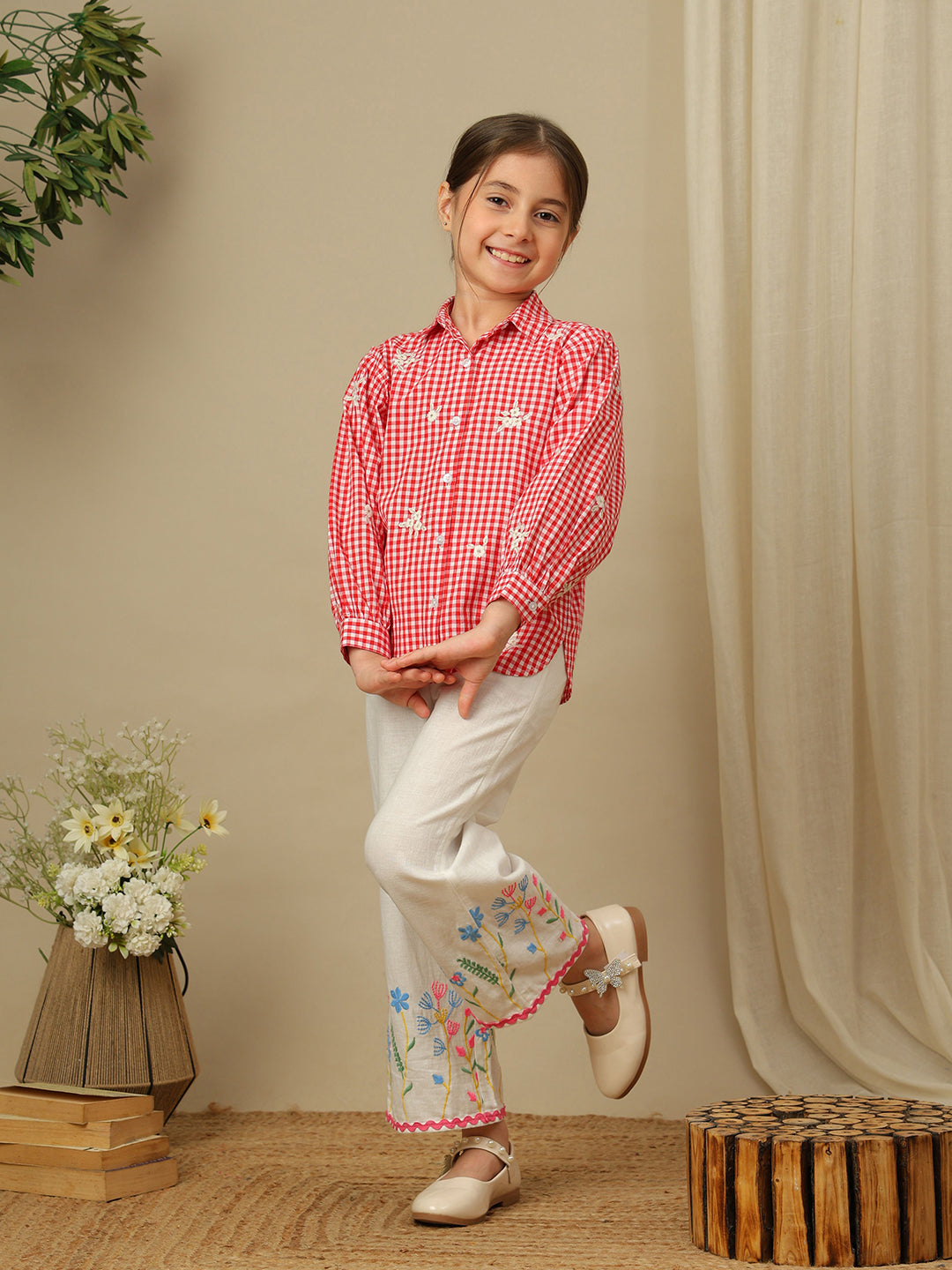Girls red and white checked cotton shirt with floral embroidery, collared neck, button-down front and full puff sleeves.