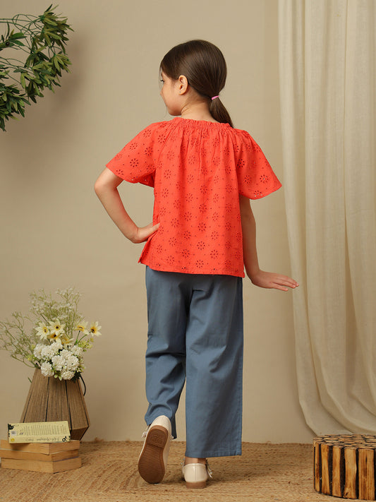 Girls cotton top with floral eyelet embroidery, gathered neckline and flutter sleeves.