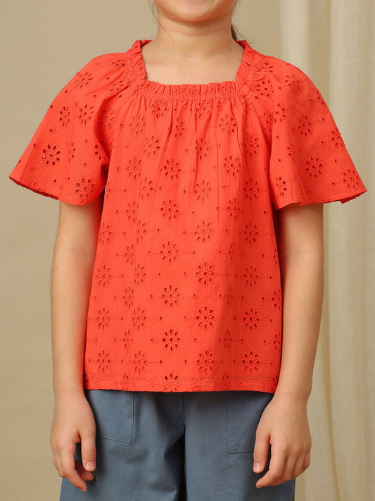 Girls cotton top with floral eyelet embroidery, gathered neckline and flutter sleeves.