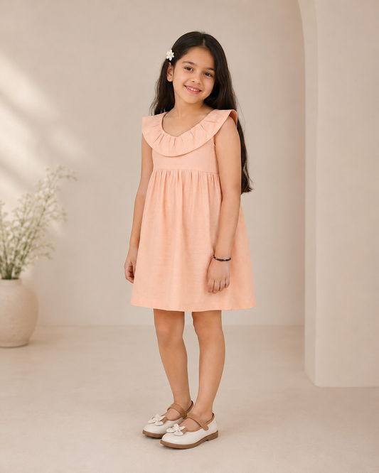 Peach girls long sleeve A-line dress with ruffle detailing and flared hem
