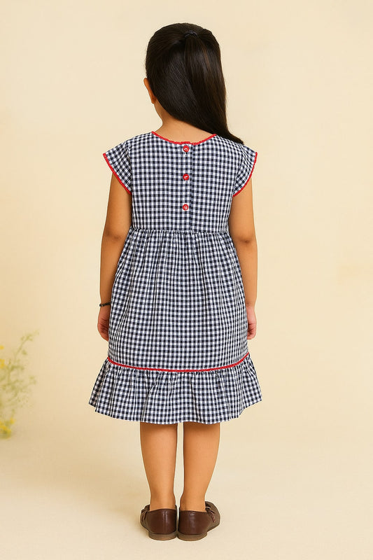 Black and white checked girls short sleeve dress with red trim and ruffle hem