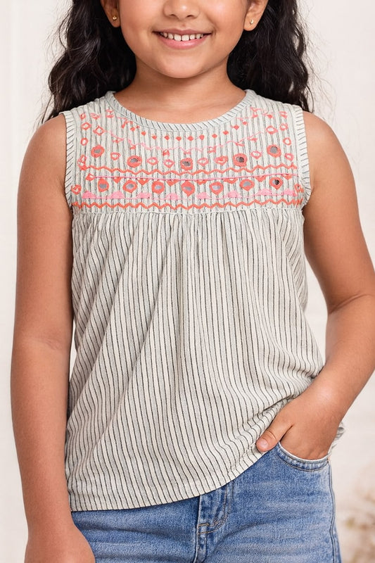 White girls sleeveless top with embroidered neckline and grey flared skirt