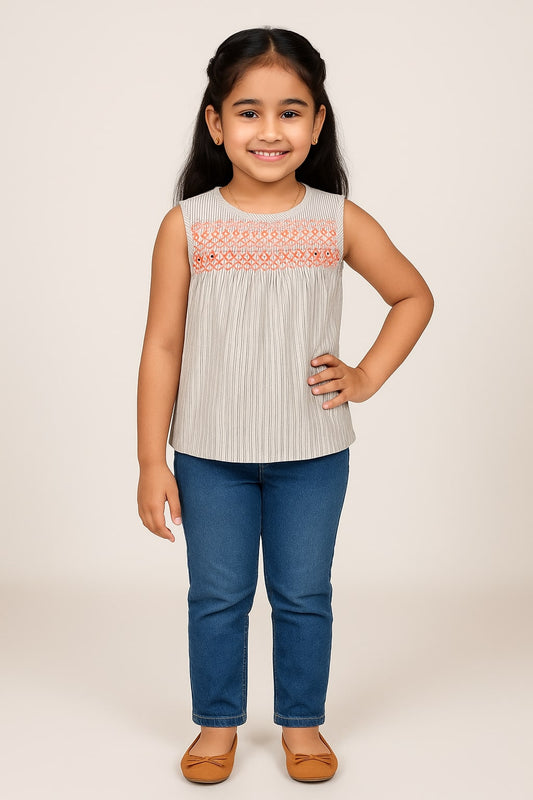 White girls sleeveless top with embroidered neckline and grey flared skirt