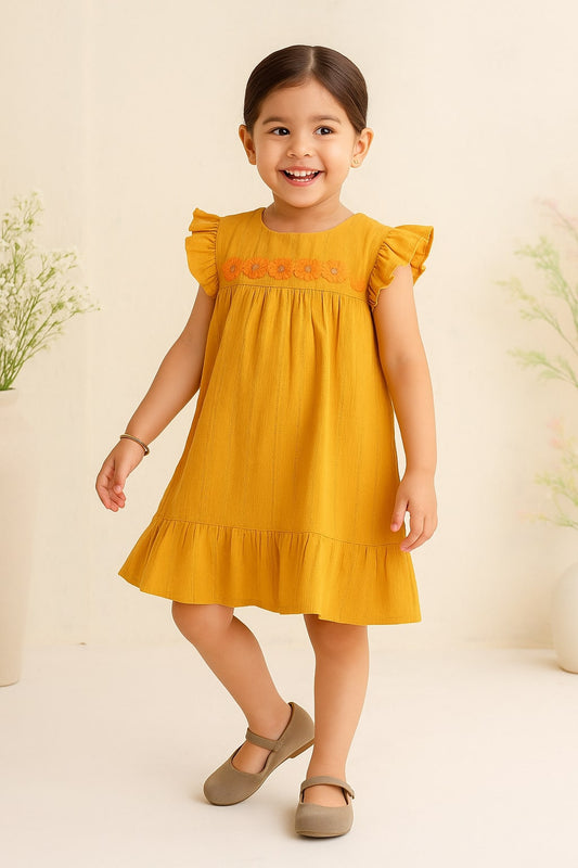 Mustard yellow girls ruffle sleeve top with gathered detailing and flared silhouette