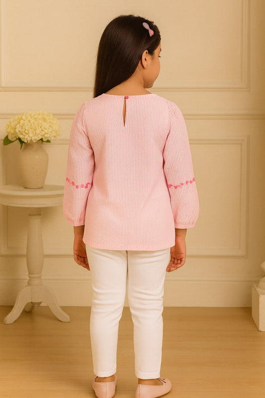 Pink girls short sleeve top with ruffle neckline and gathered sleeve detailing