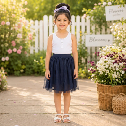 White top with navy blue girls layered tulle skirt and flared hem
