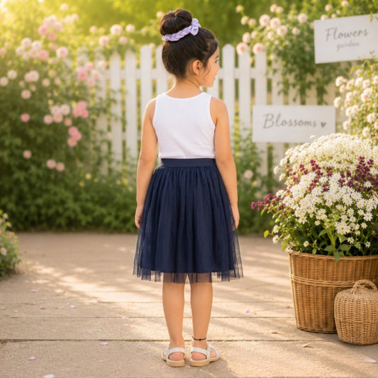 White top with navy blue girls layered tulle skirt and flared hem