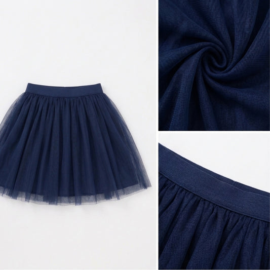 White top with navy blue girls layered tulle skirt and flared hem