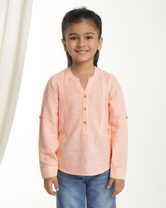 Peach girls long sleeve top with ruffle detailing and round neckline