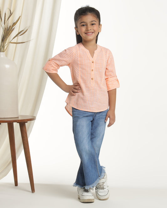 Peach girls long sleeve top with ruffle detailing and round neckline