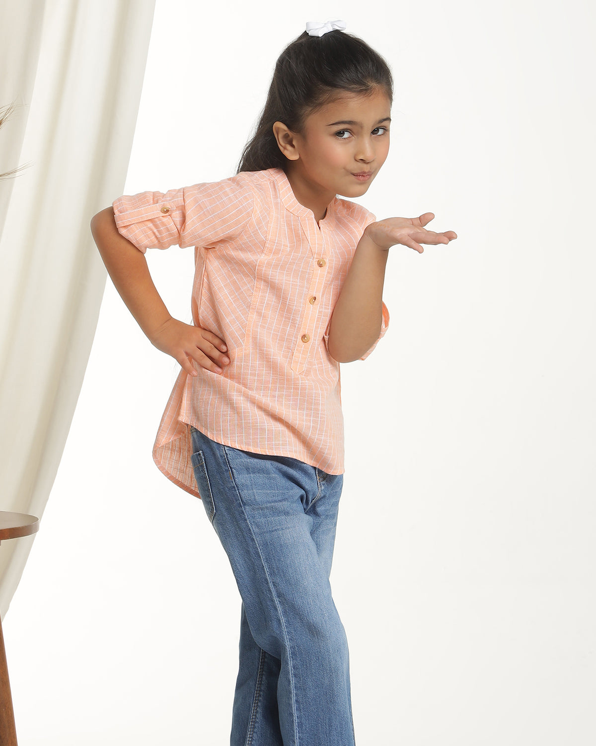 Peach girls long sleeve top with ruffle detailing and round neckline