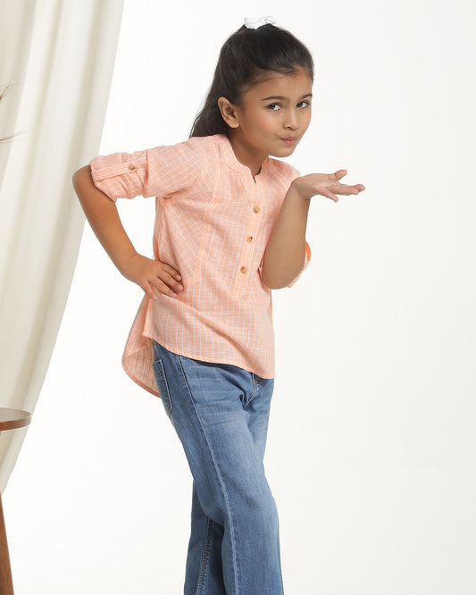 Peach girls long sleeve top with ruffle detailing and round neckline