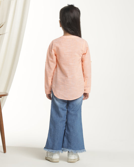 Peach girls long sleeve top with ruffle detailing and round neckline