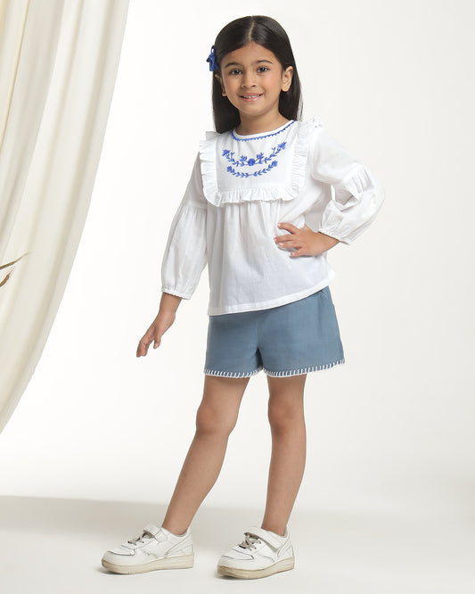 White girls long sleeve top with navy heart print and contrast trim