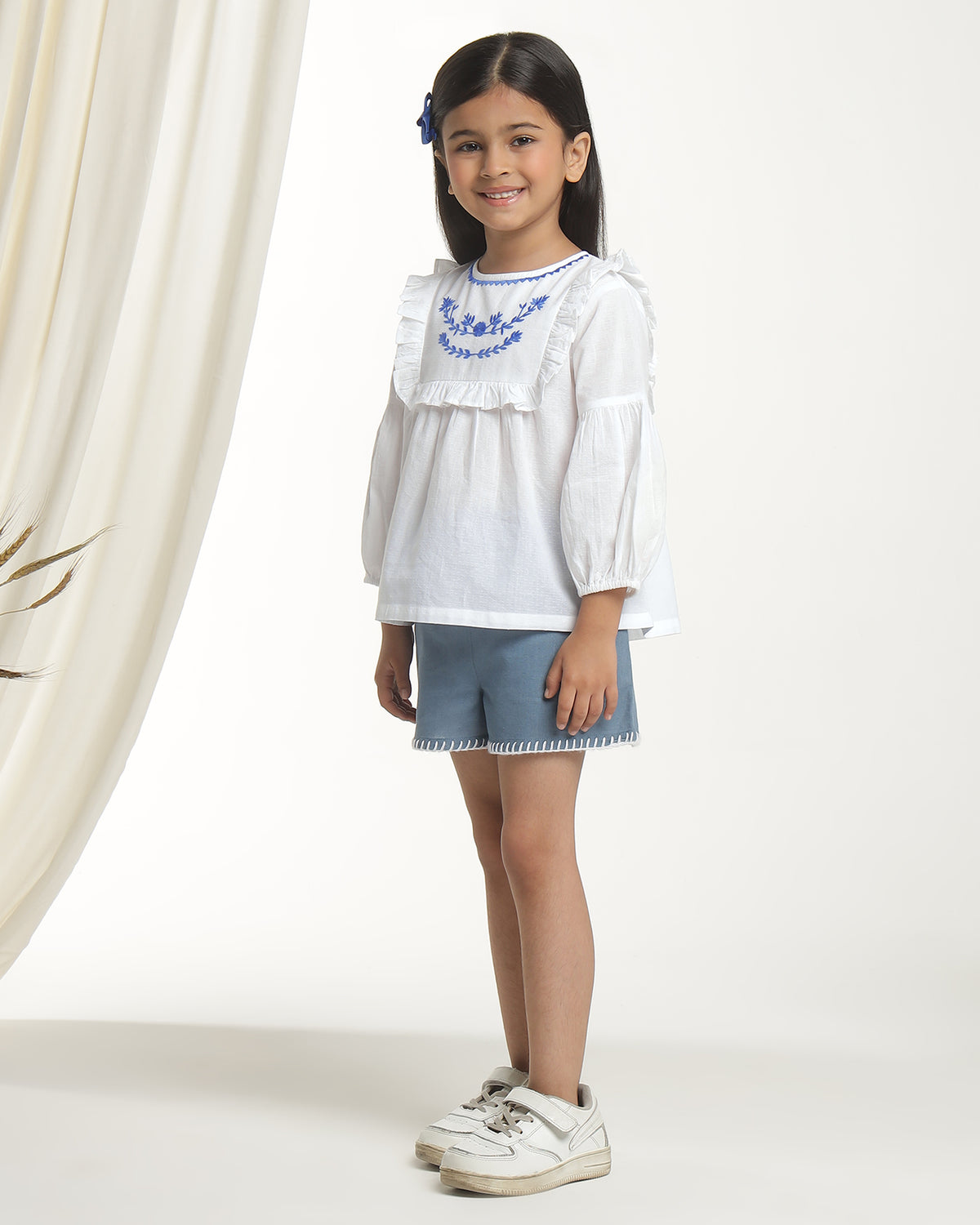 White girls long sleeve top with navy heart print and contrast trim