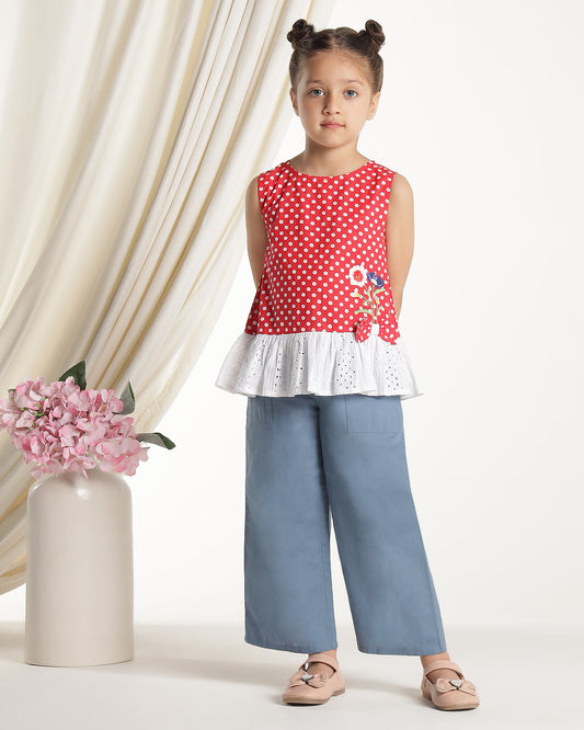 Red and white polka dot girls sleeveless dress with striped ruffle hem and floral applique