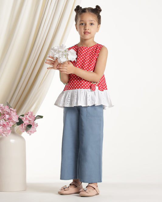 Red and white polka dot girls sleeveless dress with striped ruffle hem and floral applique