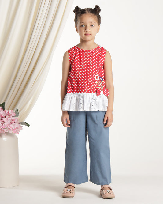 Red and white polka dot girls sleeveless dress with striped ruffle hem and floral applique