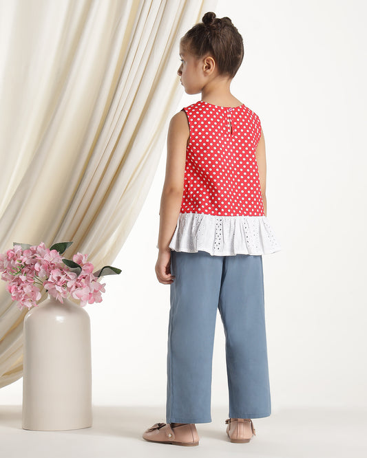 Red and white polka dot girls sleeveless dress with striped ruffle hem and floral applique