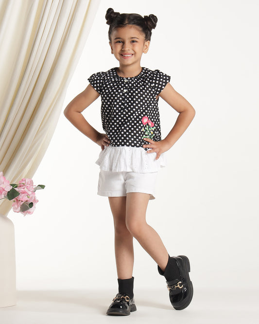 Black and white polka dot girls short sleeve dress with floral applique and ruffle hem