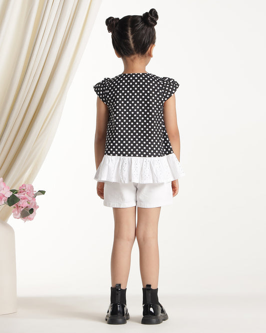 Black and white polka dot girls short sleeve dress with floral applique and ruffle hem