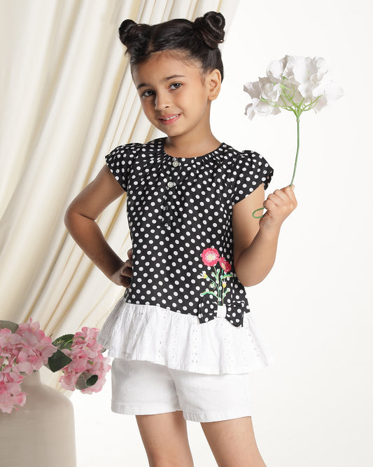 Black and white polka dot girls short sleeve dress with floral applique and ruffle hem