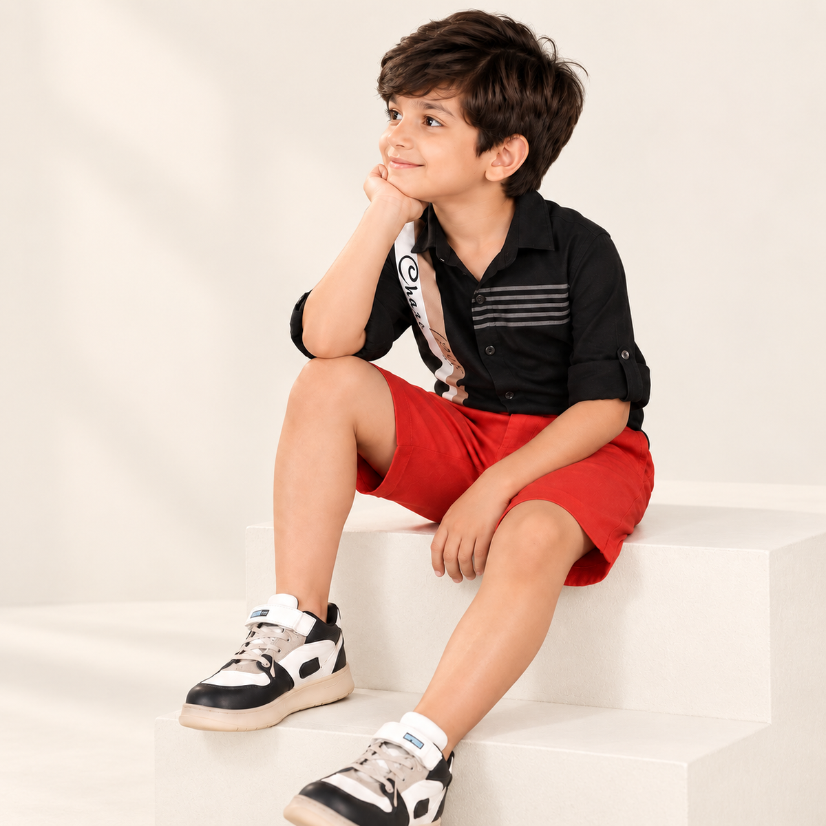 Red boys casual shorts with elasticated waist and knee-length fit
