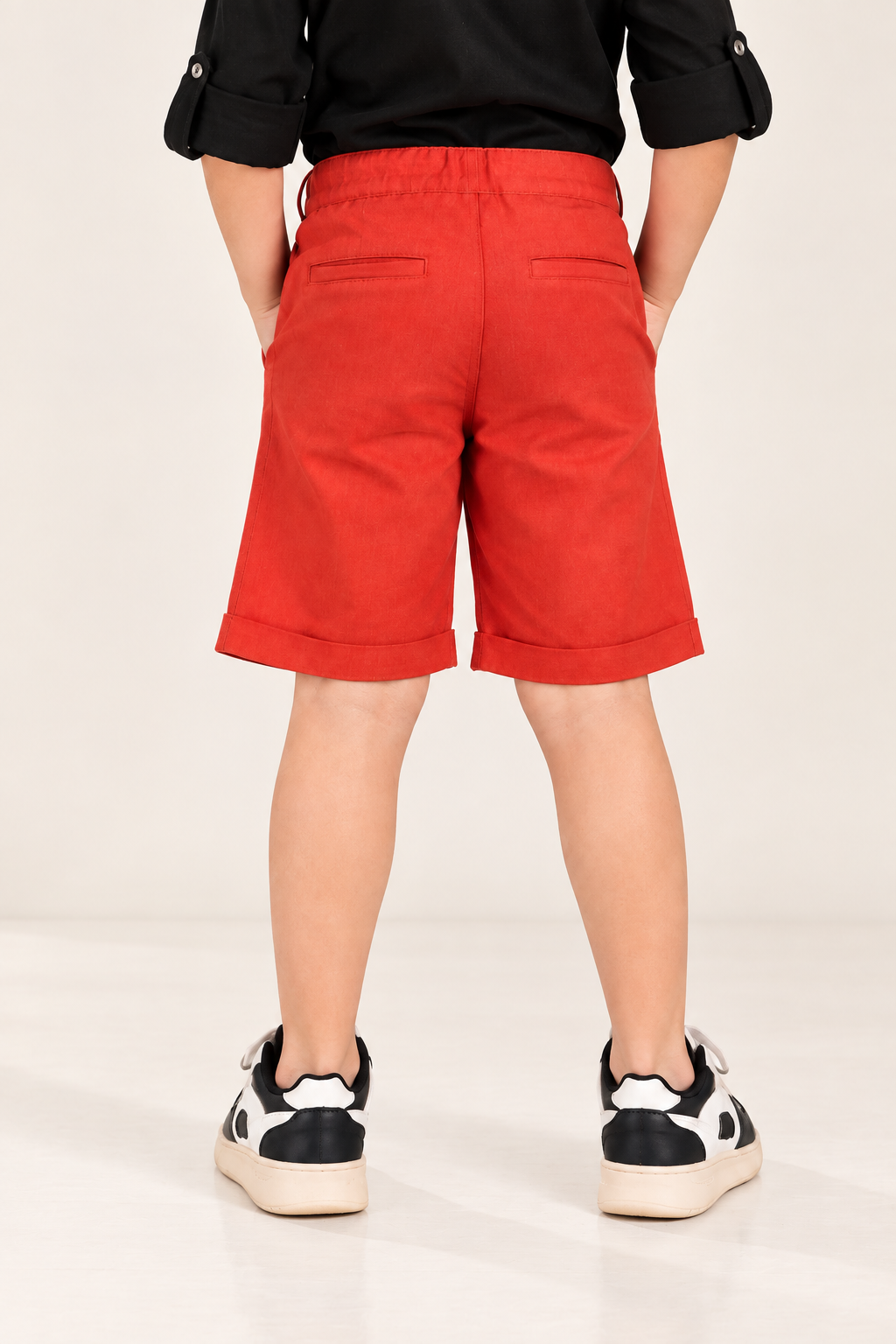 Red boys casual shorts with elasticated waist and knee-length fit
