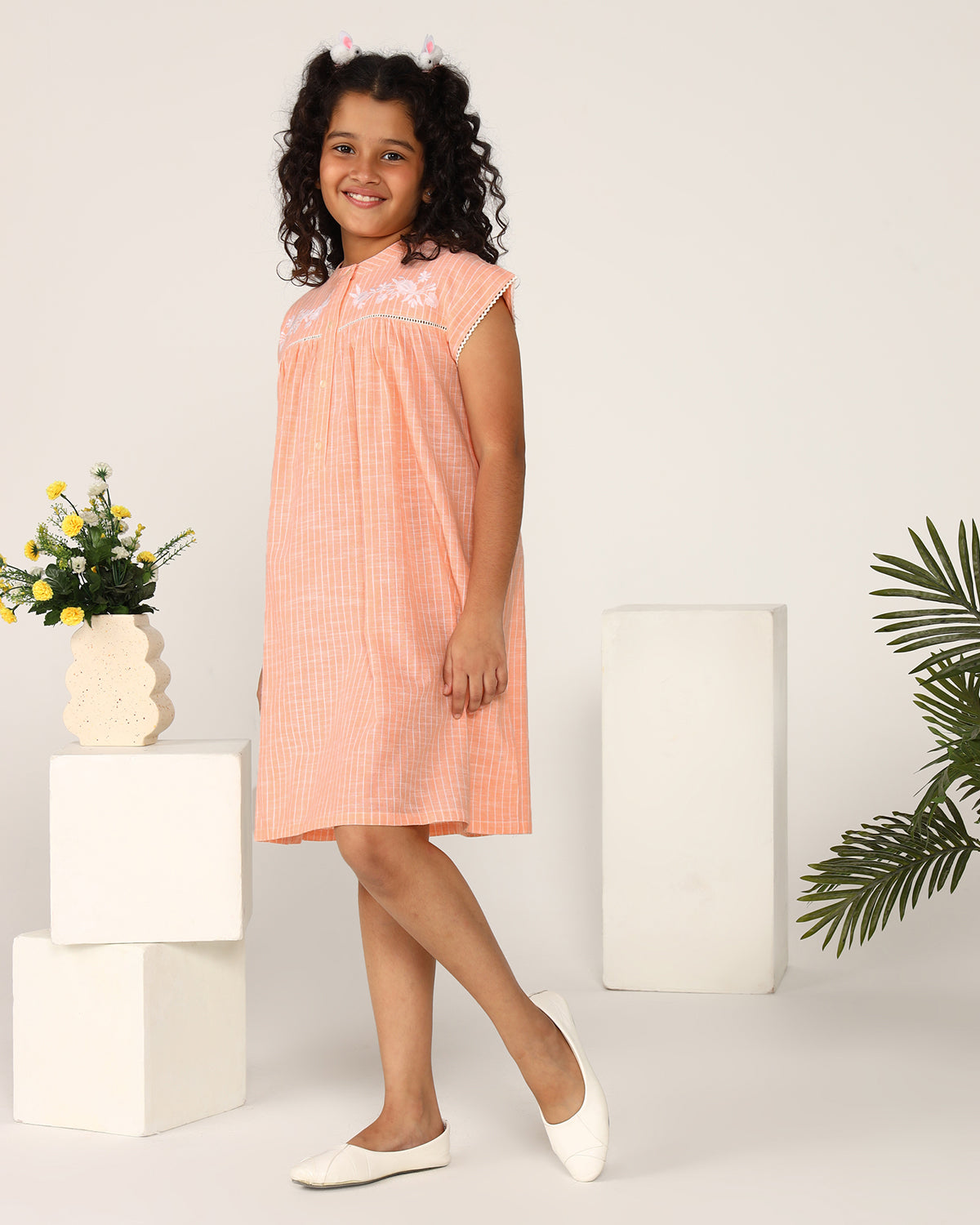 Peach girls sleeveless jumpsuit with wide-leg pants and minimal detailing