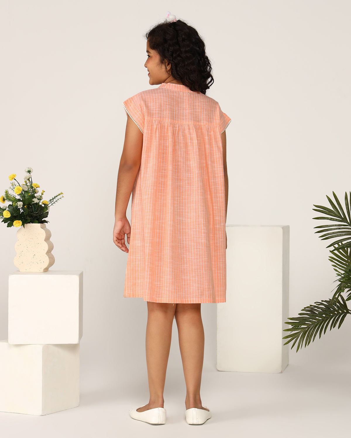 Peach girls sleeveless jumpsuit with wide-leg pants and minimal detailing