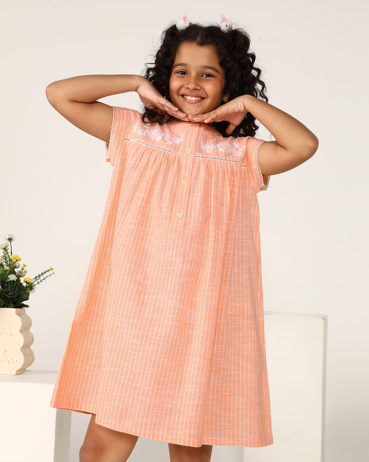 Peach girls sleeveless jumpsuit with wide-leg pants and minimal detailing