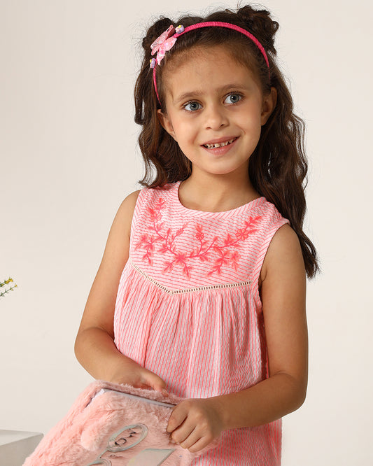 Pink girls sleeveless A-line dress with ruffle detailing and flared hem