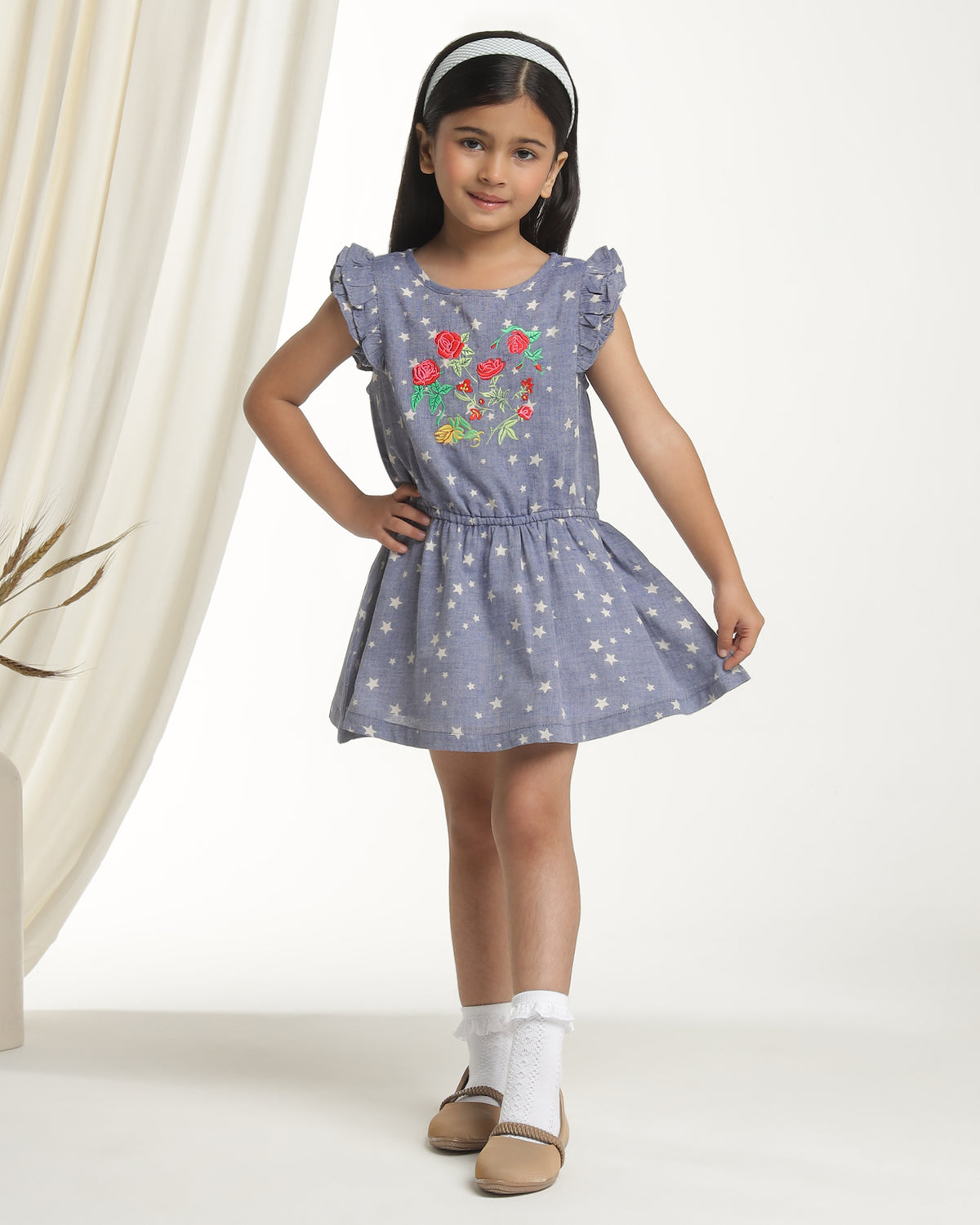 Navy blue girls printed sleeveless dress with gathered waist and flared skirt